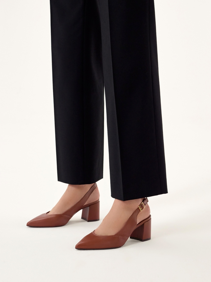 Brown pumps on a post with an open heel