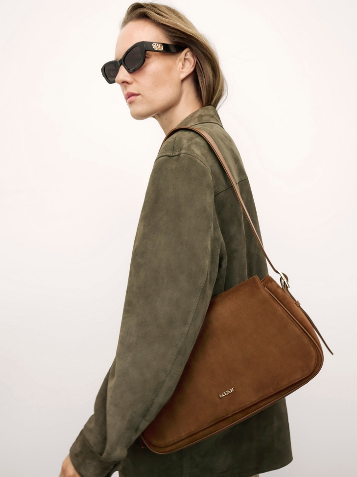 Light brown suede handbag with KAZAR logo.