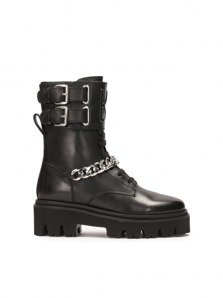 Black boots with decorative flap and chain
