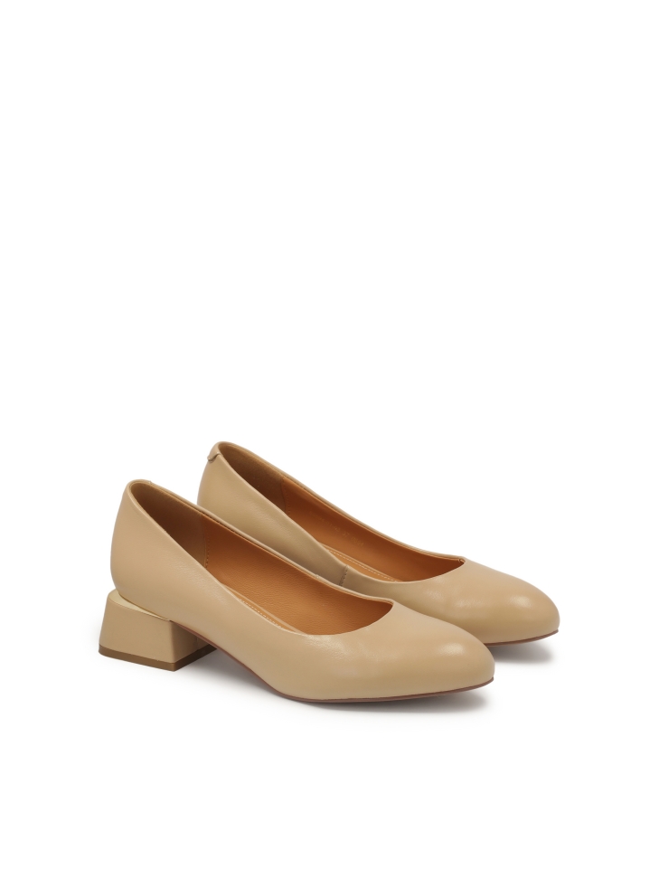 Beige pumps with metal insert on a post