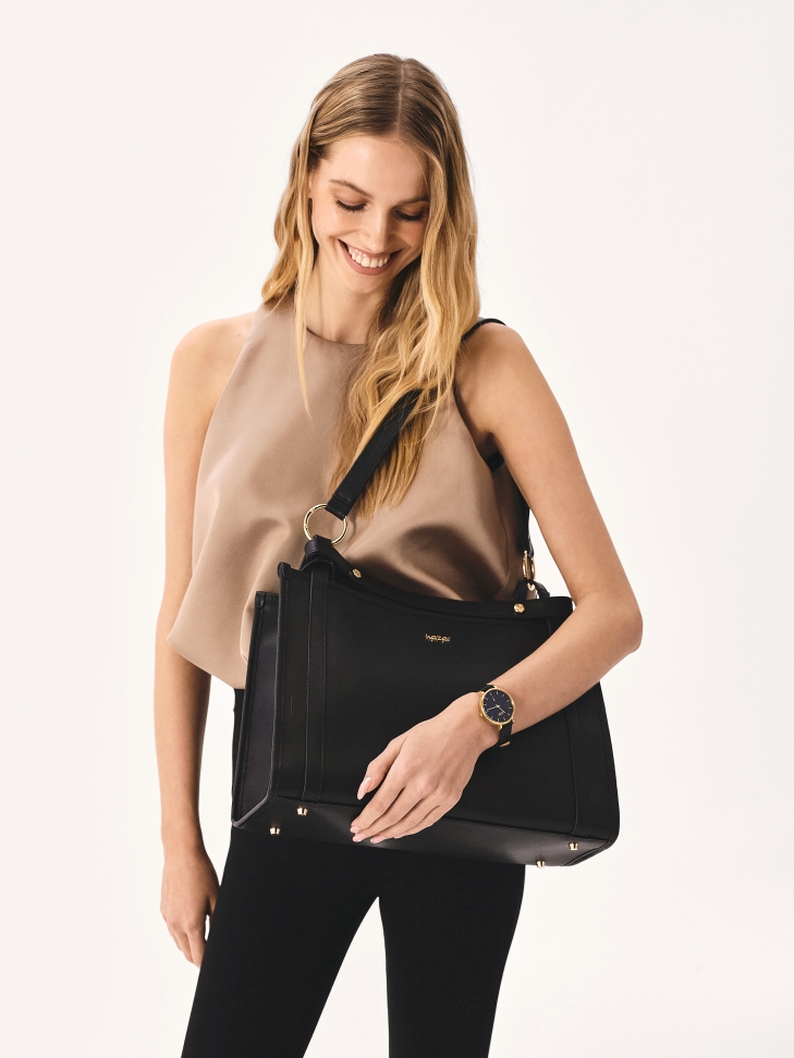 Black and gold watch on a leather strap