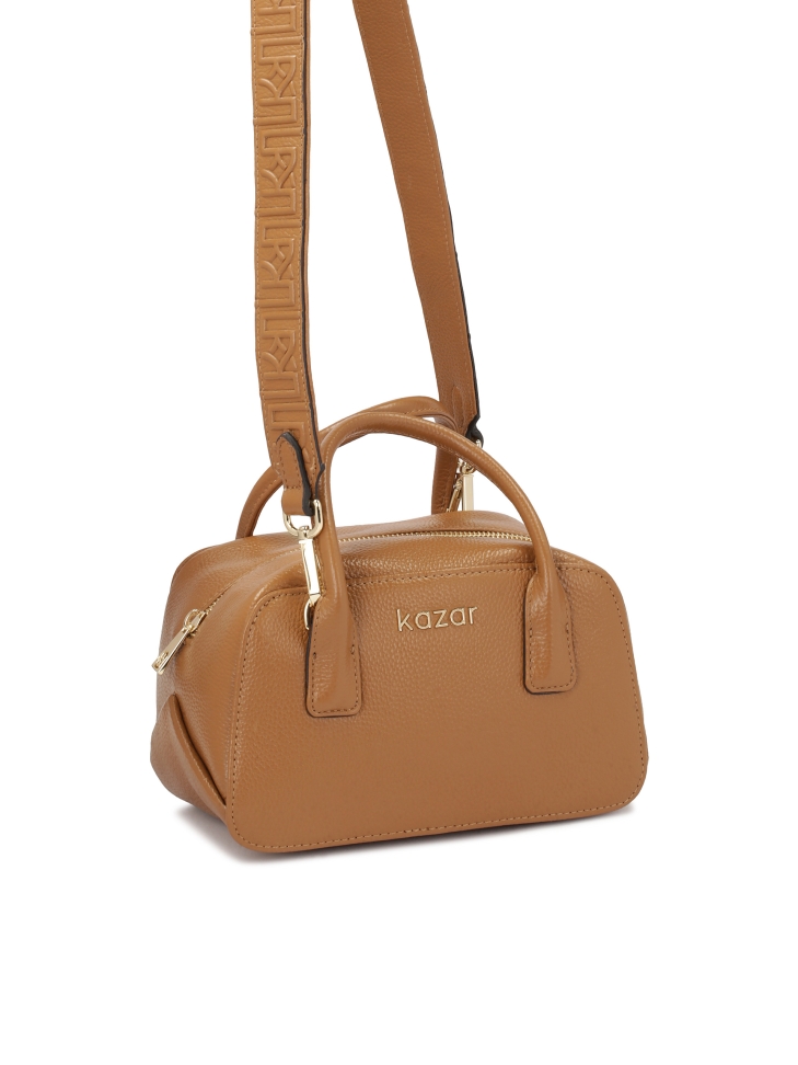 Small handbag of the chest type with a decorated strap