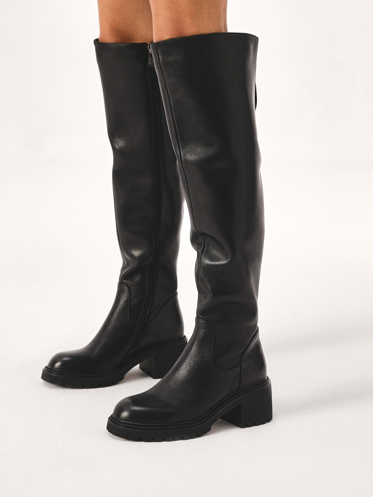 Leather black boots with an upper below the knee
