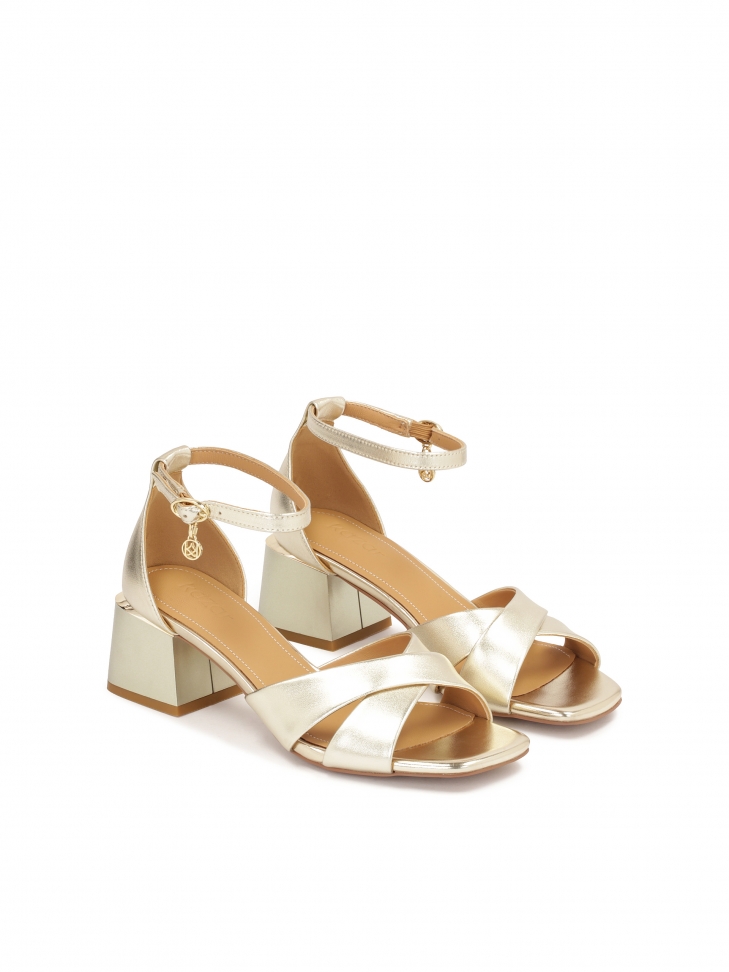 Classic sandals on a low post in gold color