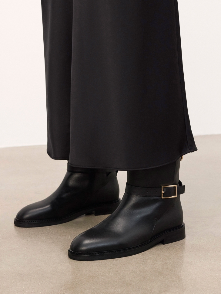 Black slip-on natural leather boots with decorative buckle
