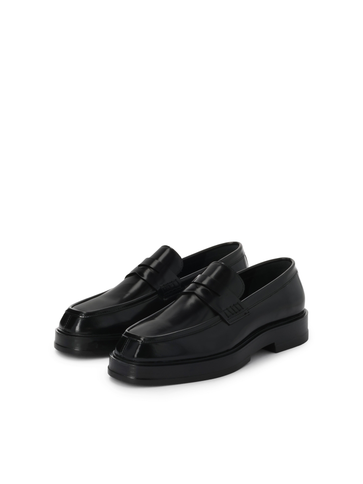 Black slip-on loafers on a higher sole