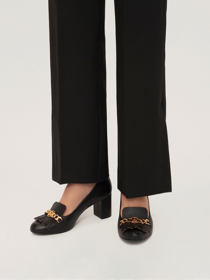 Elegant black pumps on a block heel decorated with chain