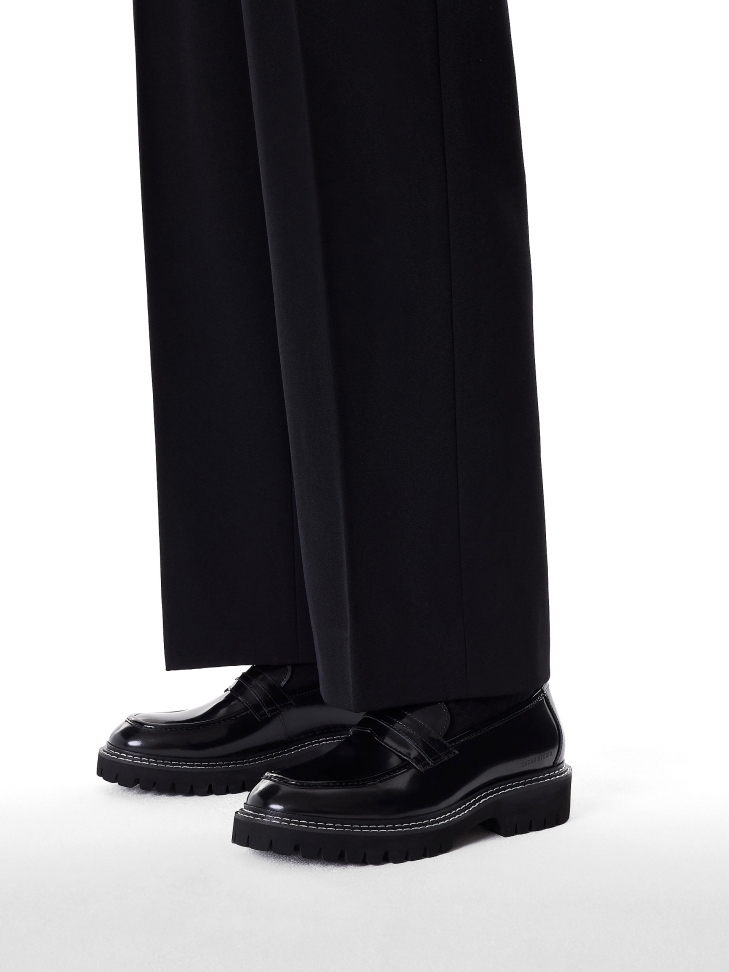 Black loafers stitched with white thread