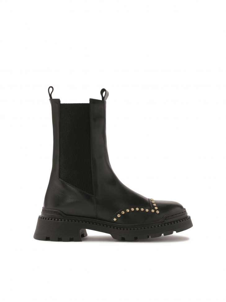 Boots with slip-on upper decorated with round rivets