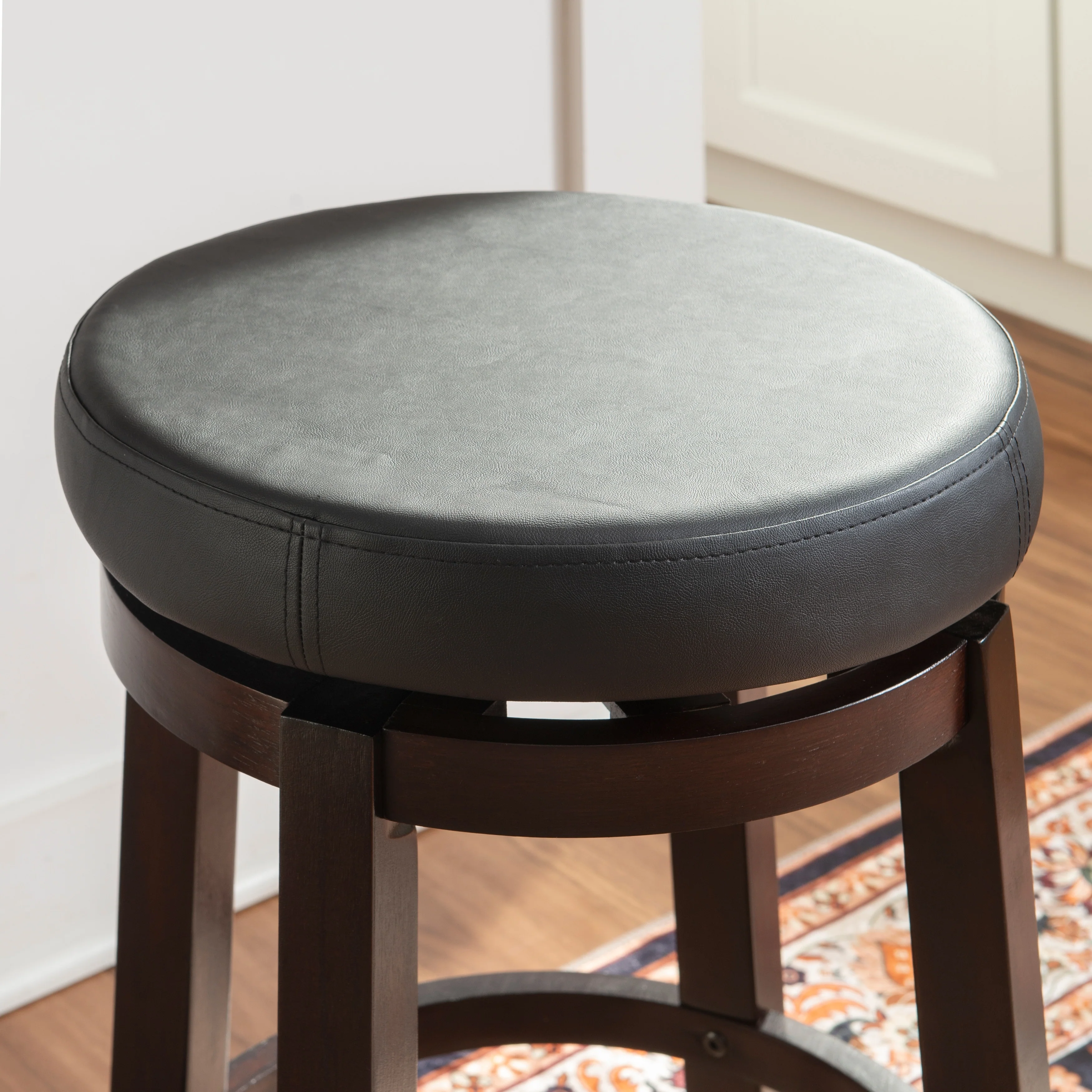Dorothy Black Wood 25-Inch Backless Faux Leather Swivel Counter Stool