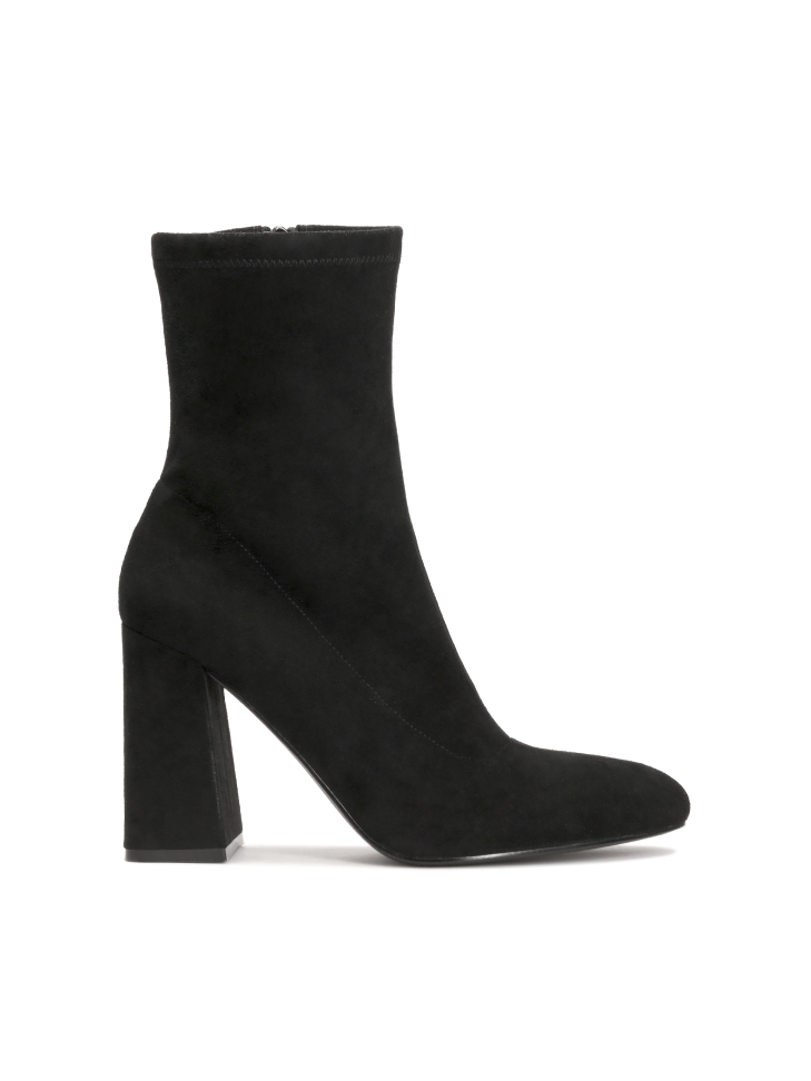 Classic black boots on a post