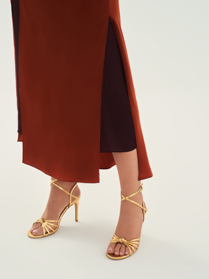 Elegant golden sandals with angled straps