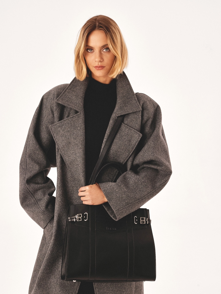 Black handbag decorated with buckle straps