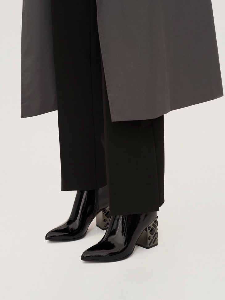 Black patent leathered booties with a metal heel decorated with crystals