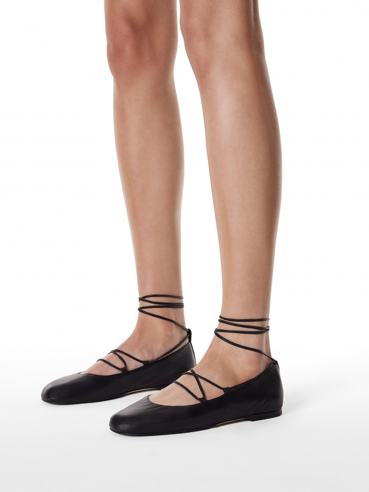 Black ballerinas tied around the ankle