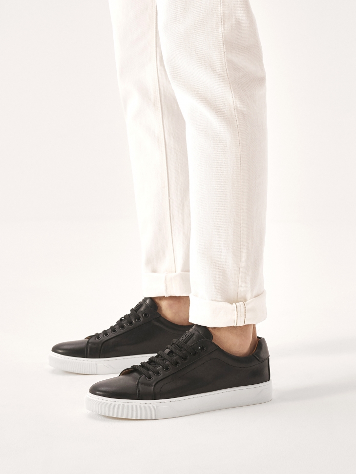 Black sneakers on a white sole