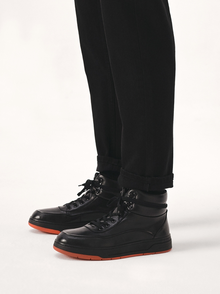 Black sneakers with contrasting red sole
