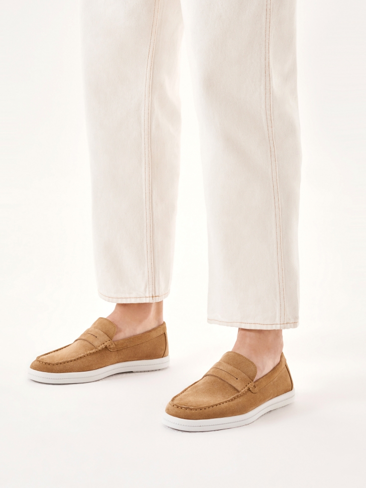 Beige slip-on sneakers on a white sole