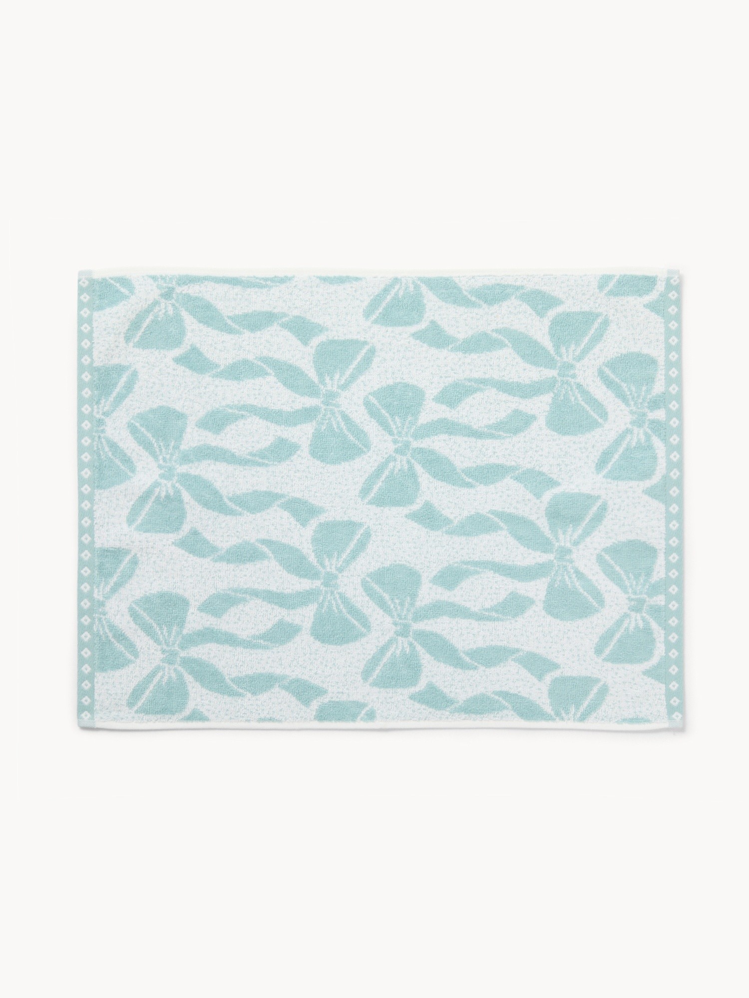 Asciugamanobicolor in spugna di cotonecon fantasia fiocchi - Prezzo di lancio