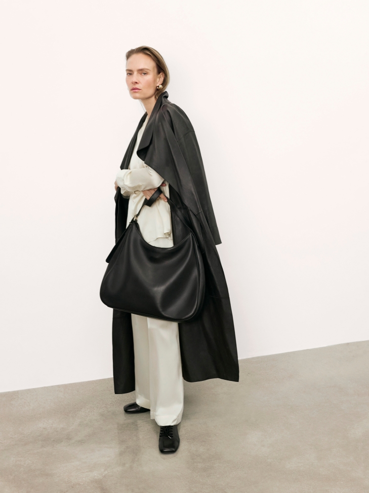 Elegant black leather handbag with trapezoidal shape