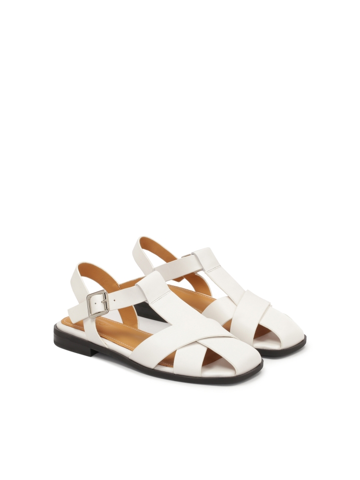 White sandals with a strap overshadowing the toes