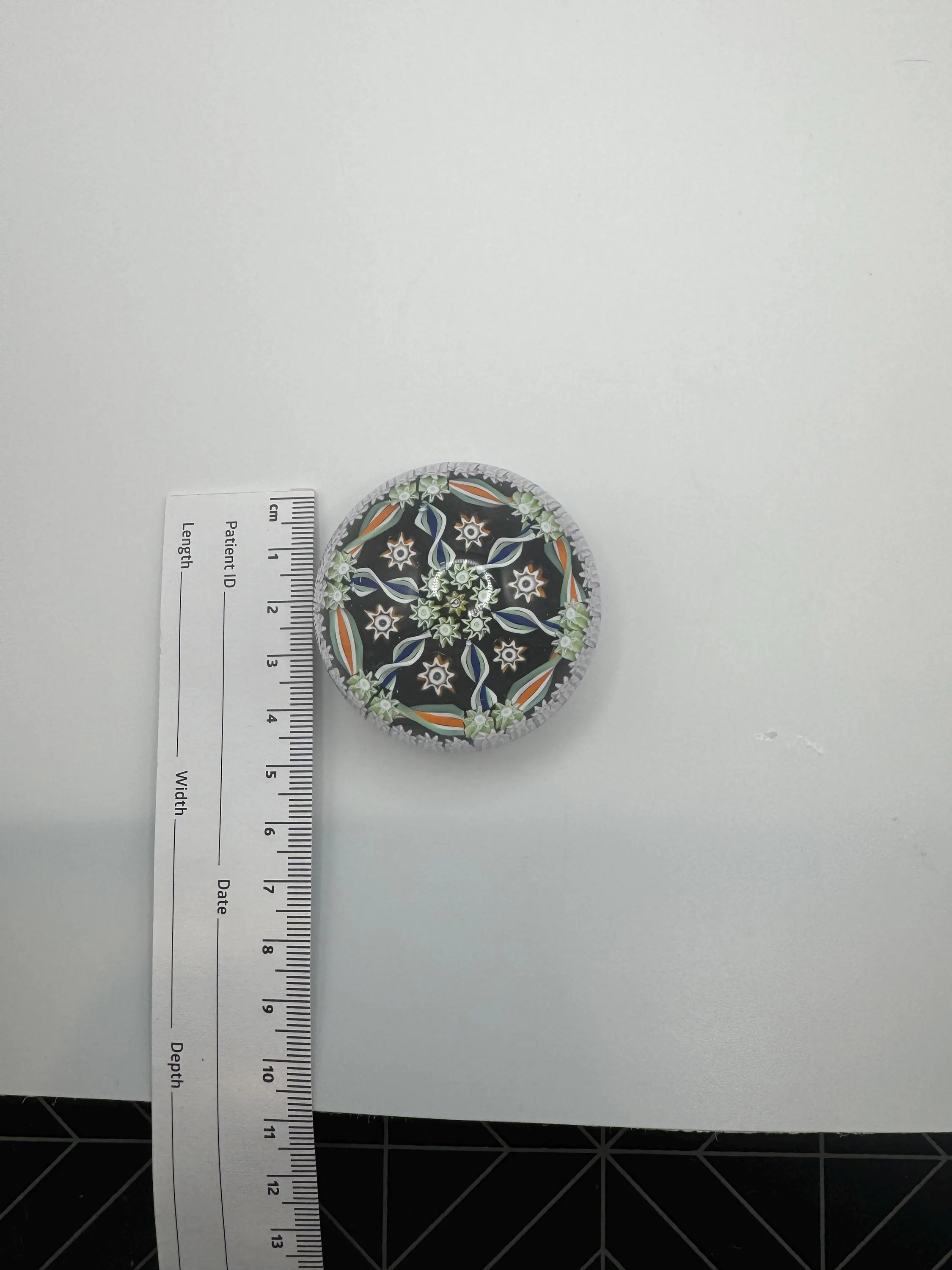 Vintage Perthshire small millefiori glass Paperweight. Brown base with oranges and greens. very good condition.