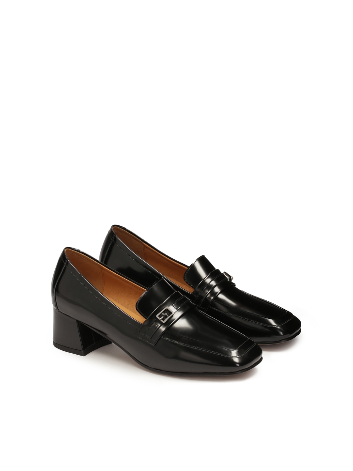 Black pumps on a block in glossy leather