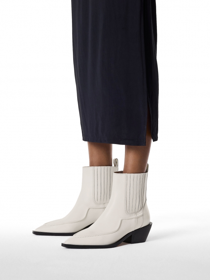 Broken white leather cowboy boots