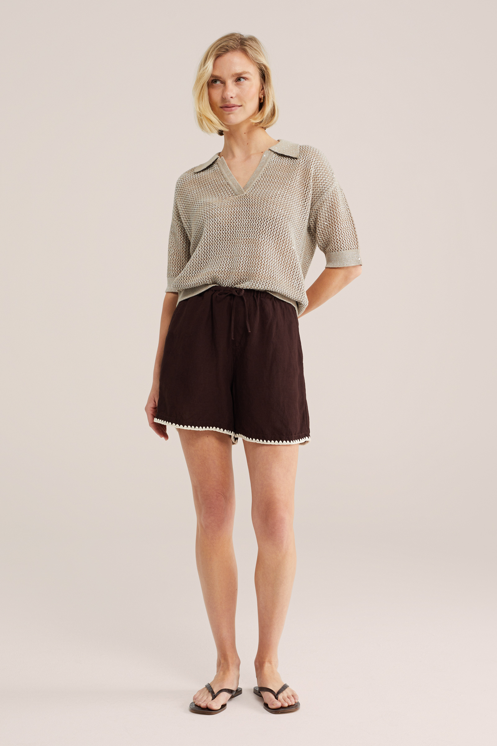 Dames gebreide polo met opengewerkte structuur