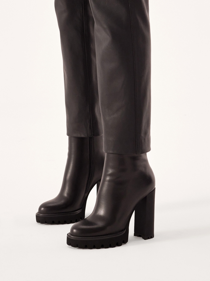 Minimalist black boots with high heel and platform