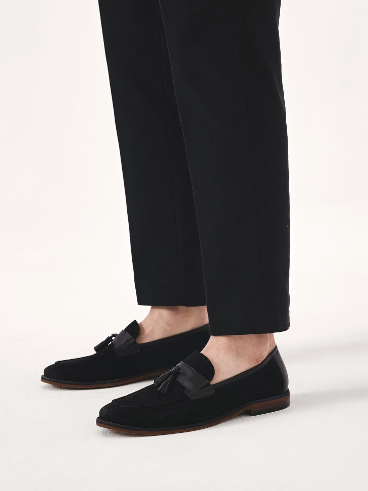 Slip-on black loafers with a clutch