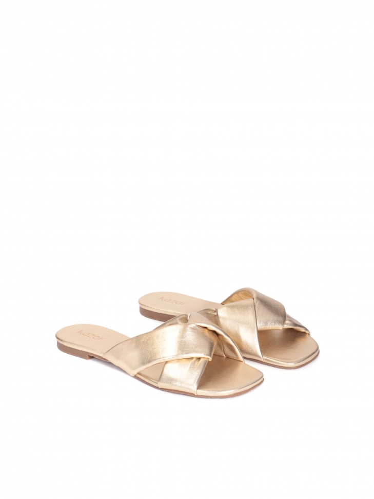 Flat slides made of golden leather