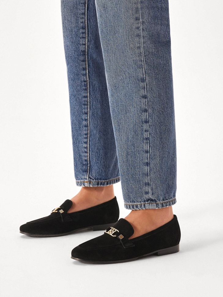 Black suede loafers with metal embellishment