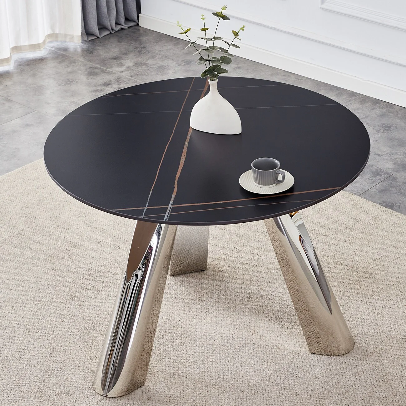 A 42-inch burn stone round table with stainless steel legs can accommodate 4 or 6 diners