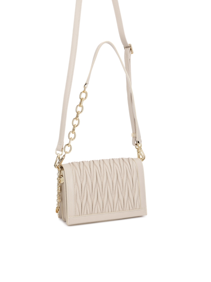 Leather handbag with decorative draping on the flap