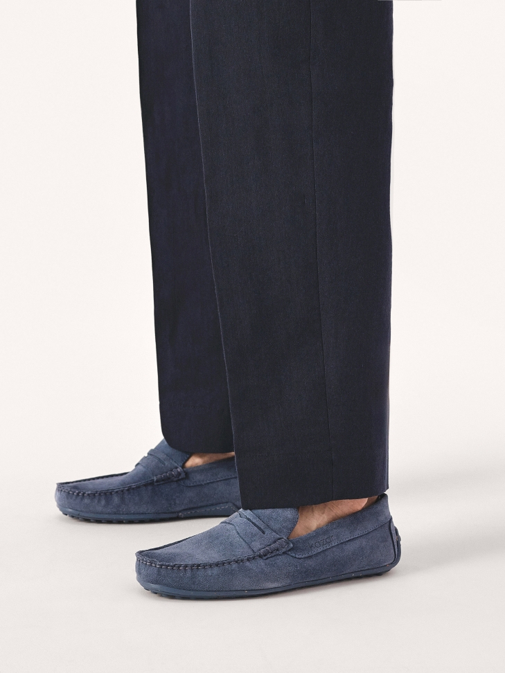 Blue suede moccasins on a studded rubber sole