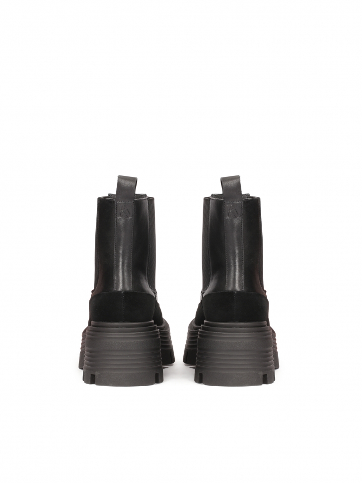 Black Chelsea boots on an elevated sole with embossing