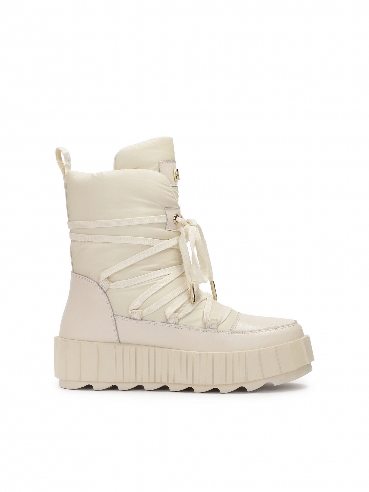 Fashionable snow boots in beige color