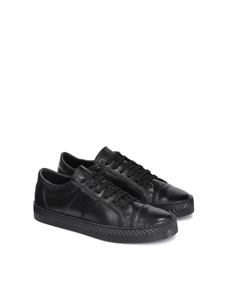 Men's black leather sneakers on a perforated sole