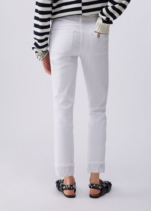 Pantaloni skinny con risvolto e strass