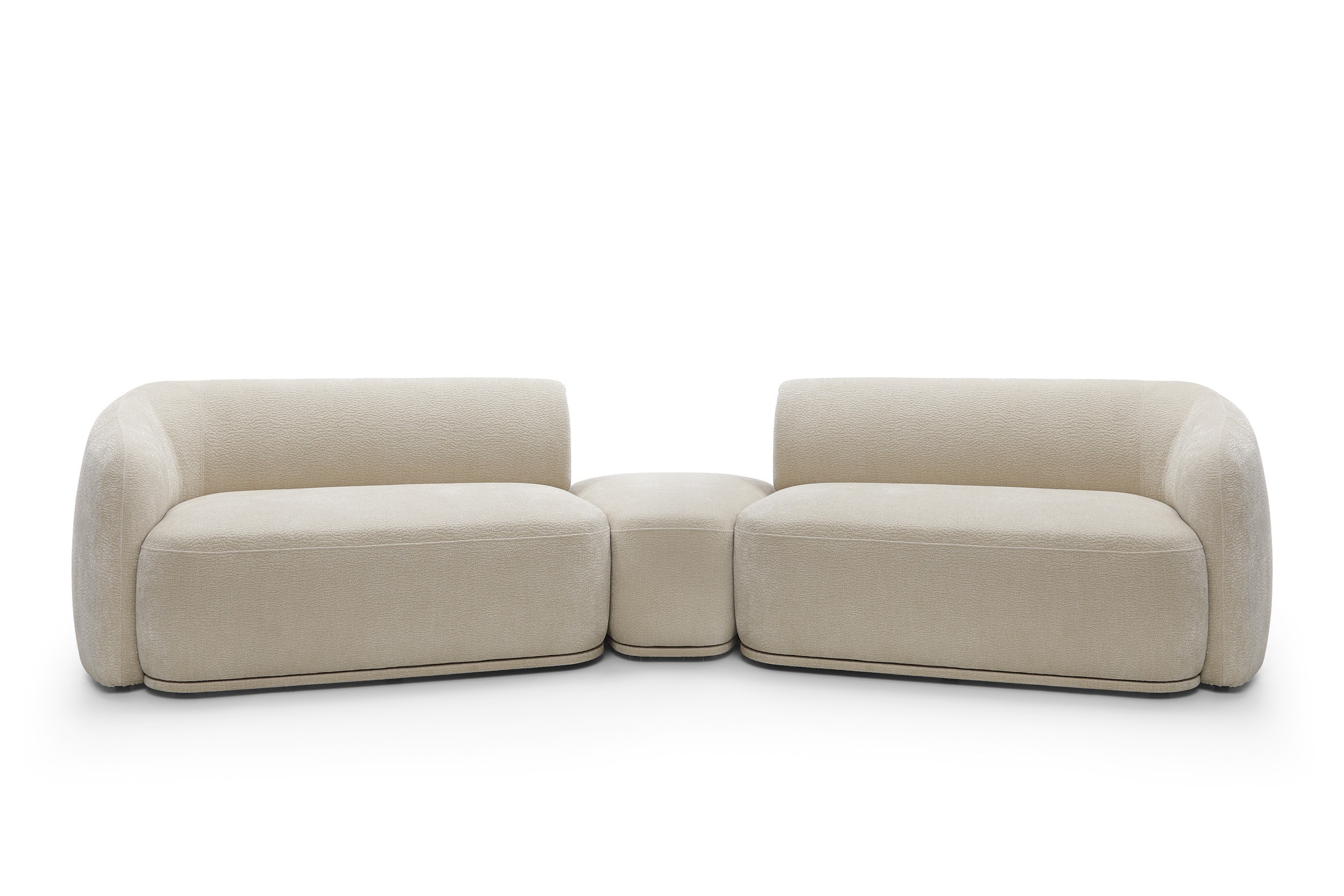 Modułowa sofa z pufą beżowa NOBIS z elegancko zaokrąglonymi bokami