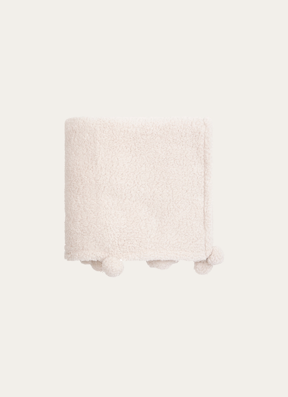 PLAID EN SHERPA AVEC FINITIONS POMPONS BEIGE