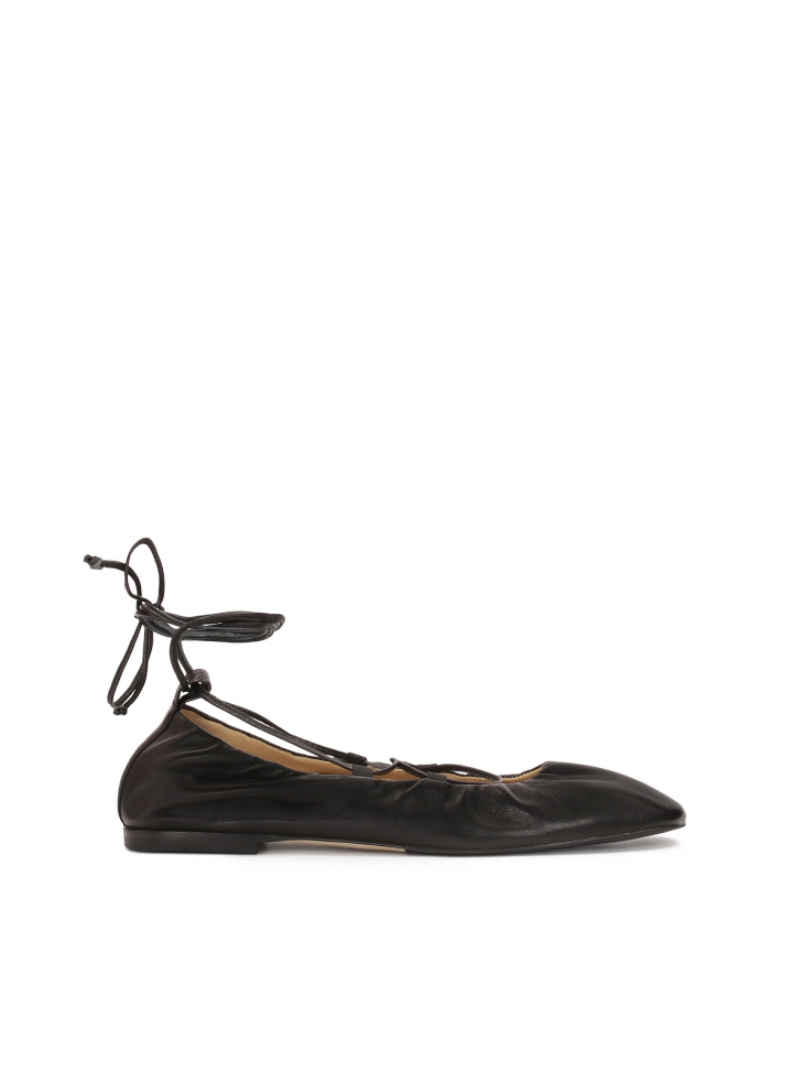 Black ballerinas tied around the ankle