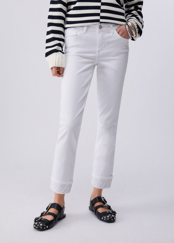 Pantaloni skinny con risvolto e strass