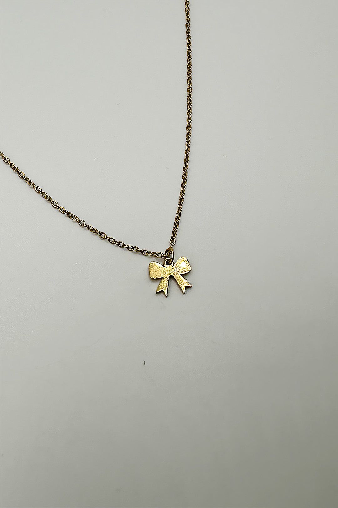 SVNX Mini Bow Pendant Necklace in Gold
