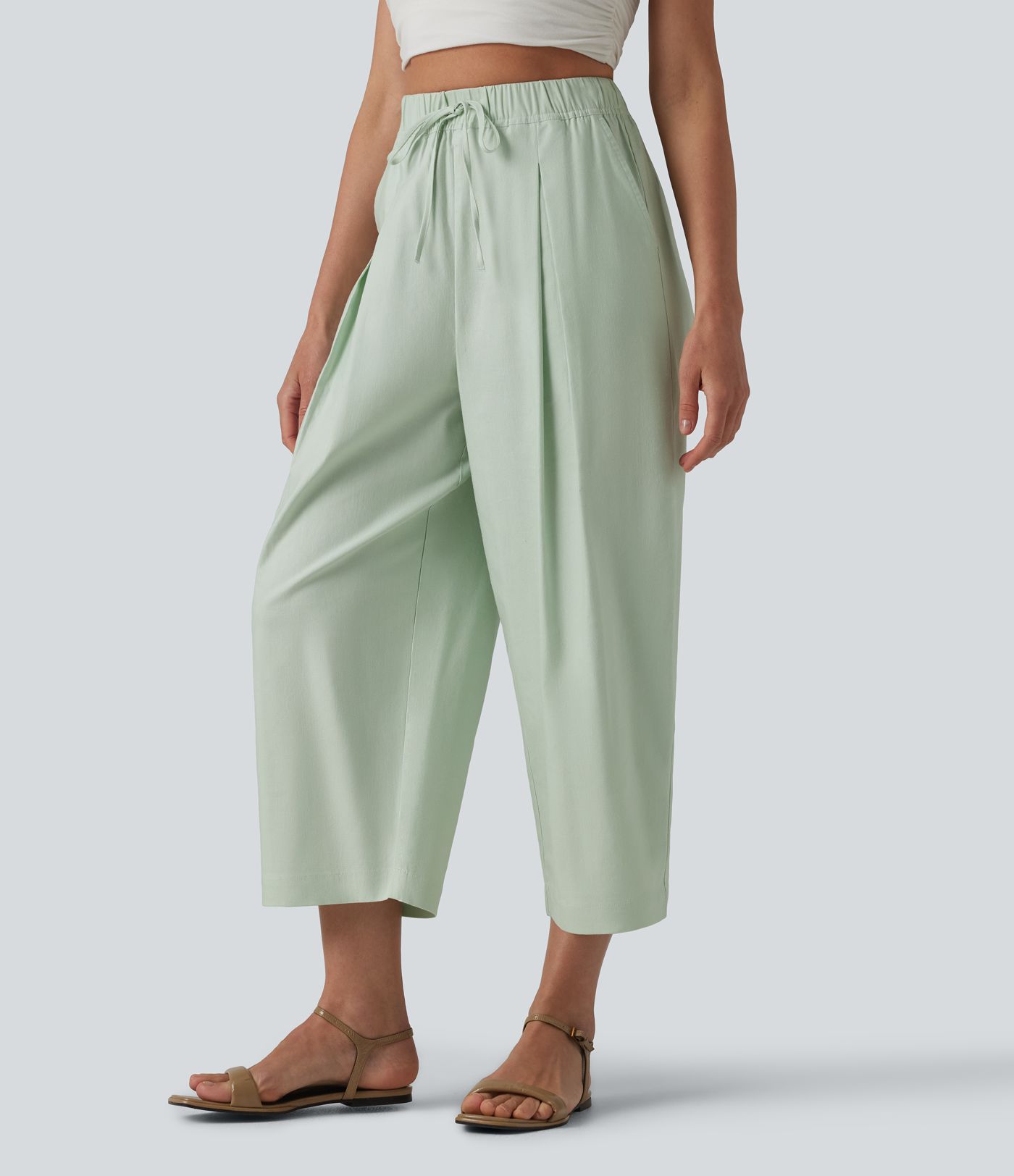 Pantalon casual court en coton et lin taille haute coupe ballon avec cordon de serrage et poches