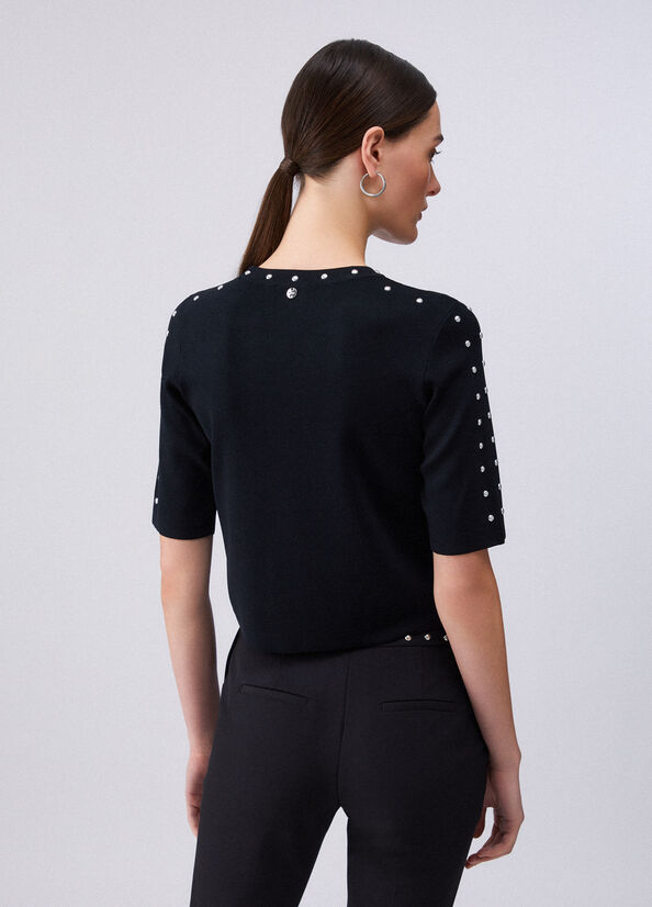 Top in maglia con borchie