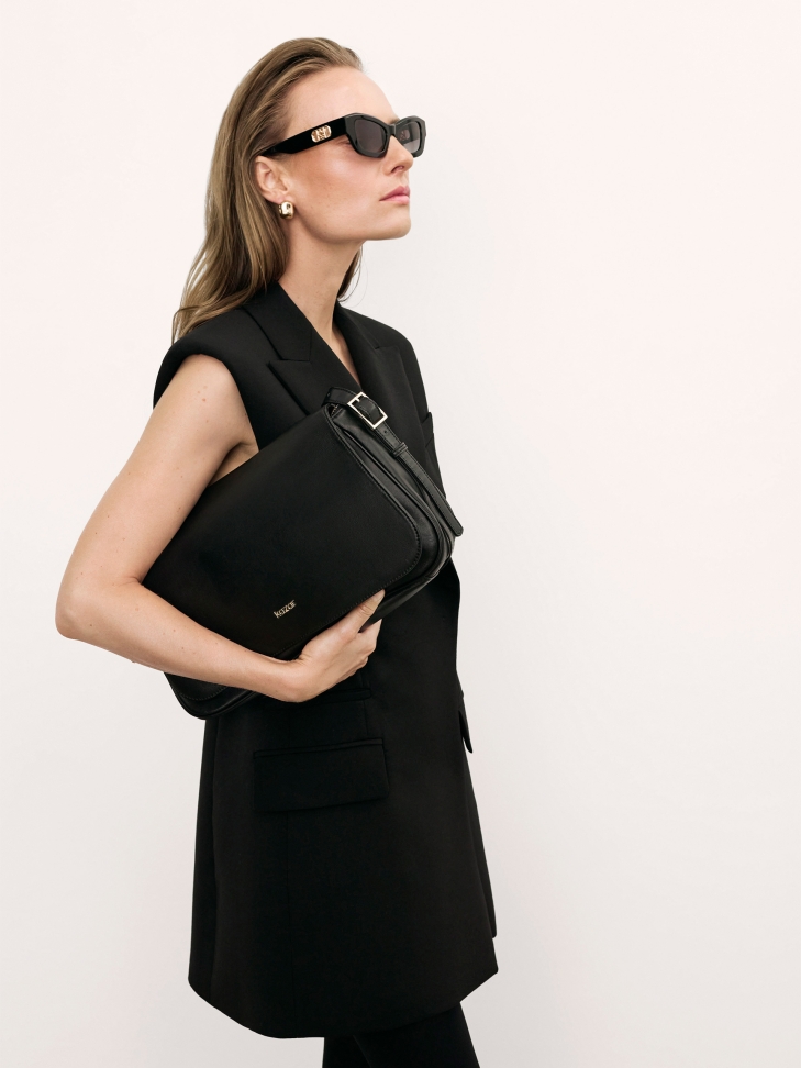 Black leather handbag with flap and adjustable strap