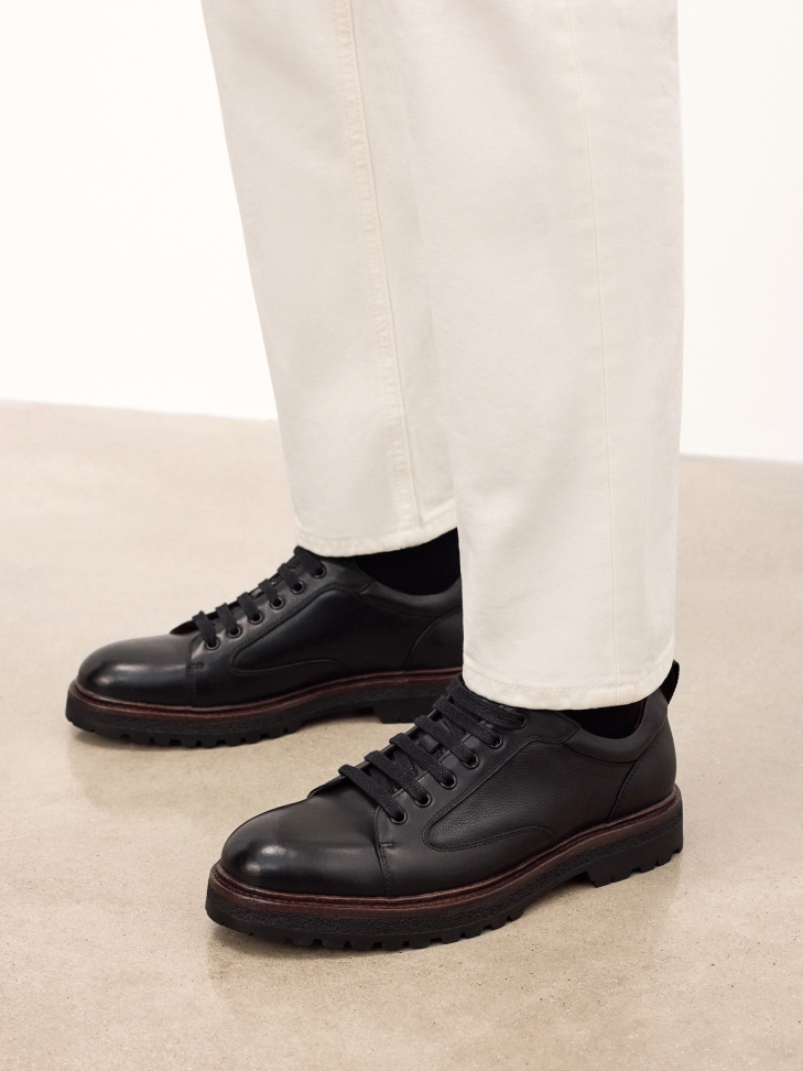 Black leather shoes with a distinctive sole