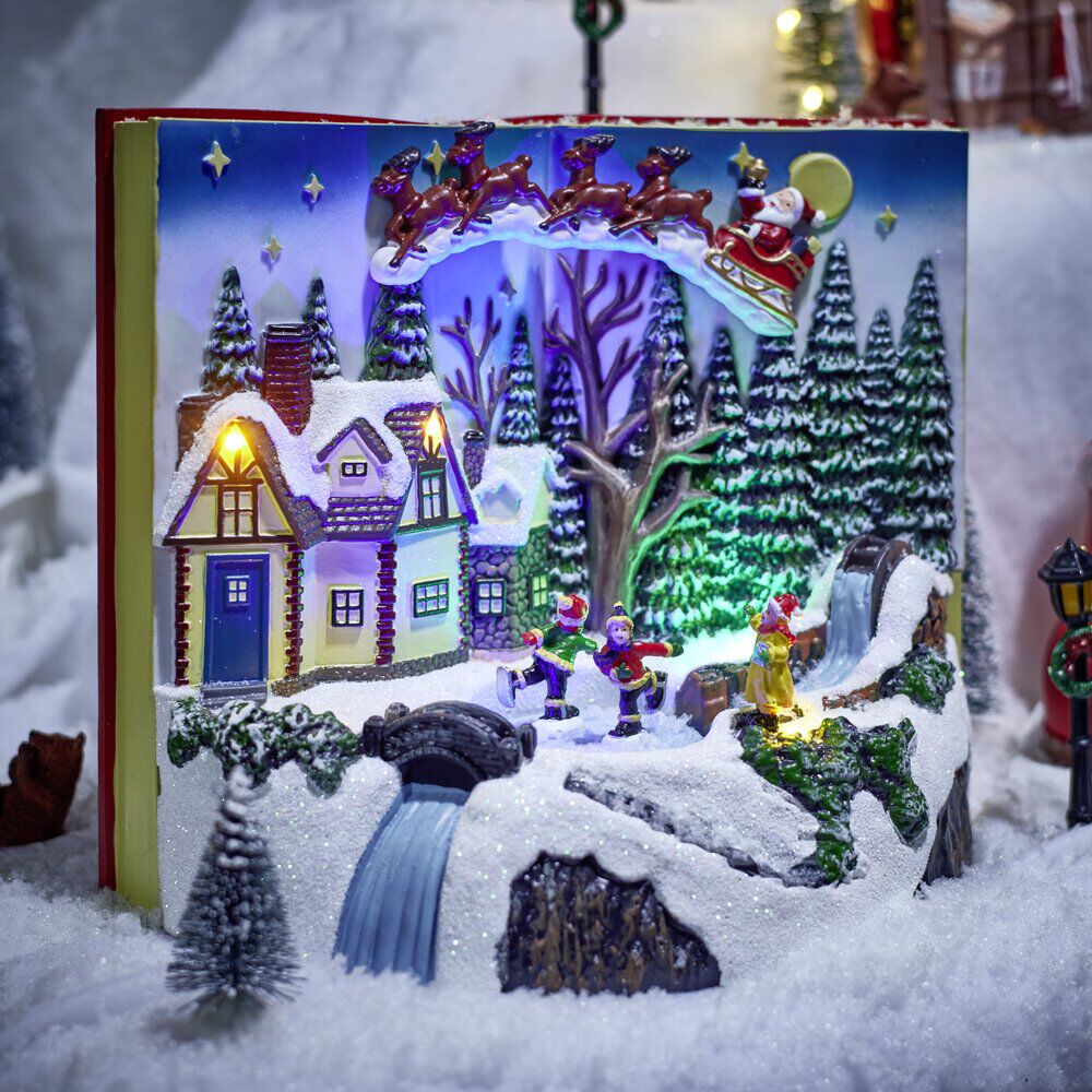 Village animé lumineux sonore façon livre ouvert avec enfants patinoire H20,5cm
